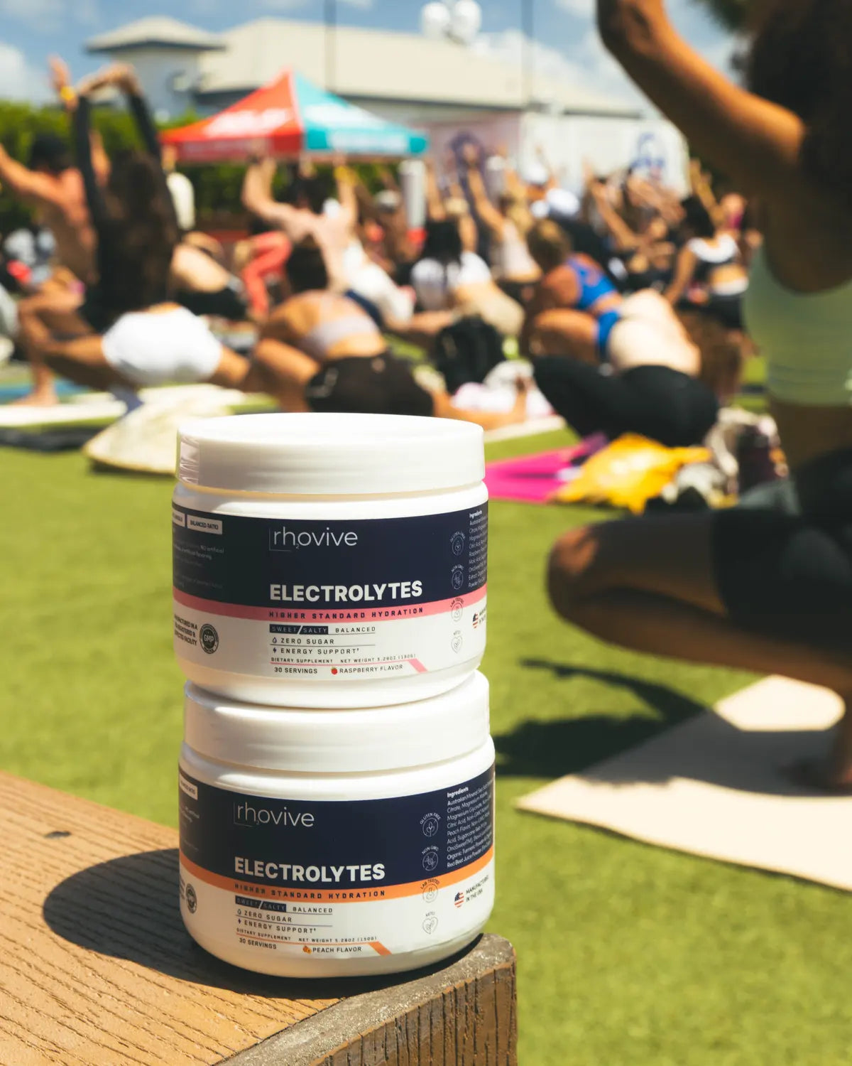 Rhovive Raspberry stacked on Peach beside an outdoor yoga class