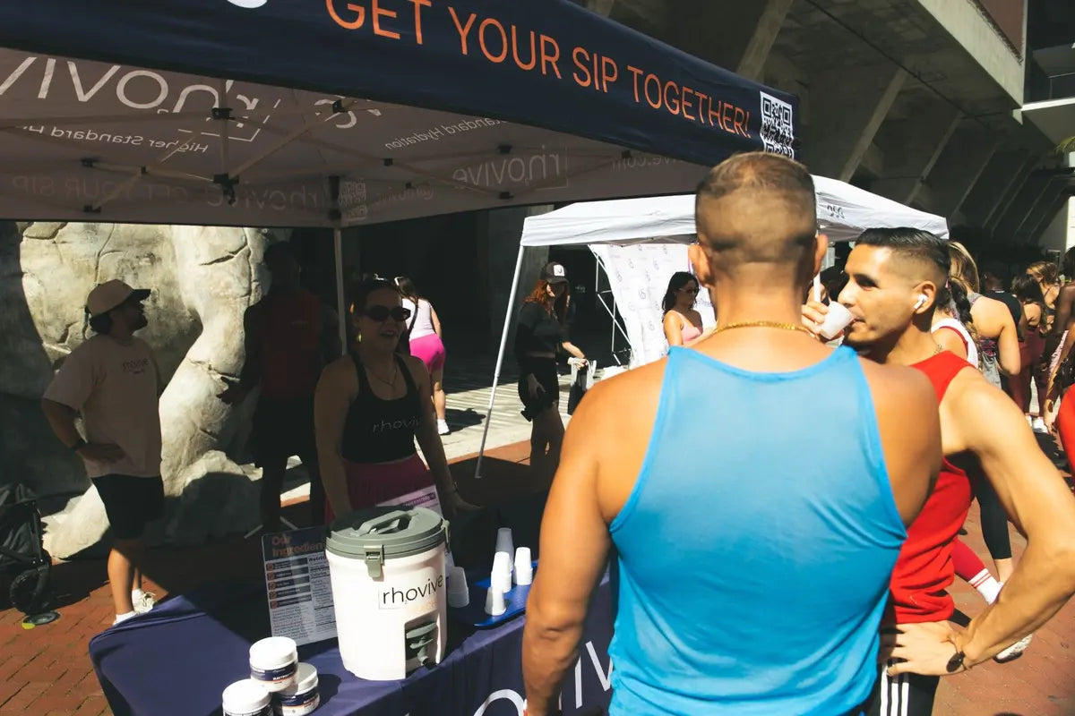 People trying Rhovive samples at the Rhovive tent