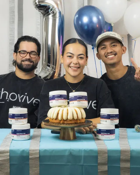 Rhovive’s three founders celebrating the brand’s first birthday with cake and jars