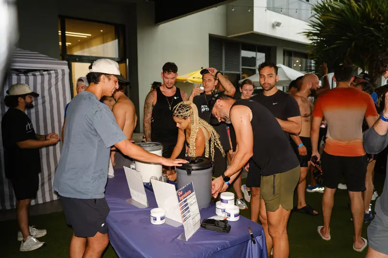 A crowd lining up for Rhovive samples after an evening workout