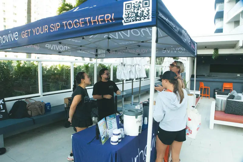 The Rhovive founders talking with visitors at the Get your sip together tent